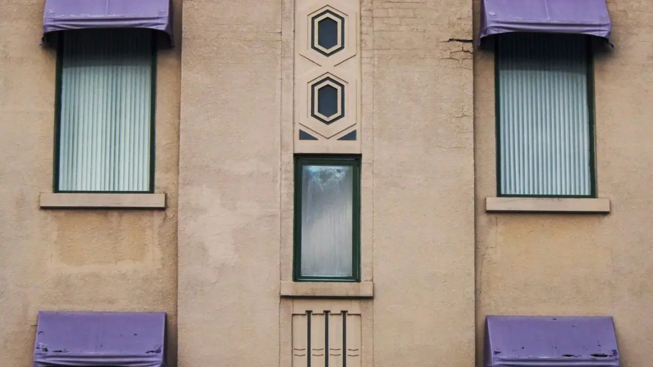 a tall building with purple awnings and windows